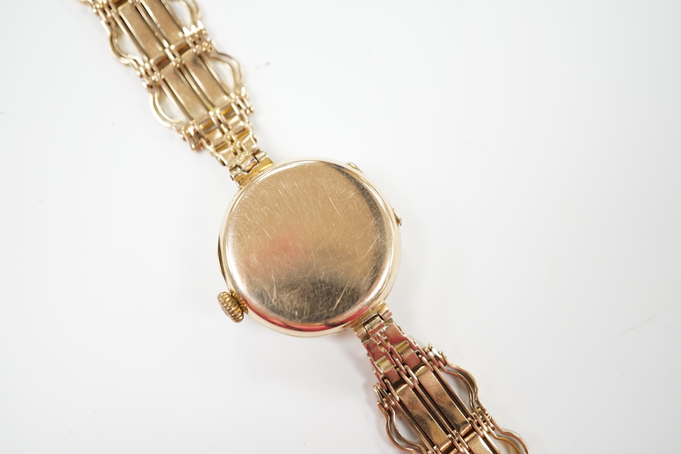 A lady's early to mid 20th century 9ct gold manual wind wrist watch(a.f.), on a yellow metal bracelet